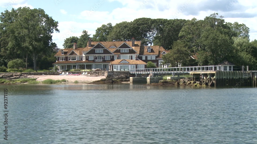 In a boat riding by houses on the water. In a boat riding by houses on the water.