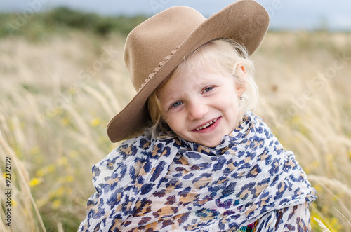 girl with hat in autumn grass