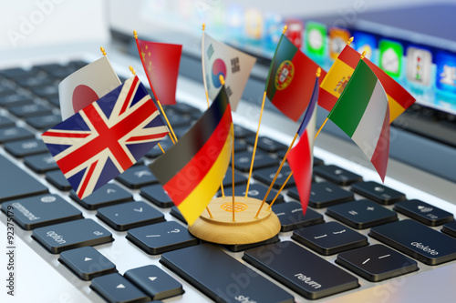 Global communication and business concept, translate and e-learning, national flags of the world countries on computer laptop keyboard