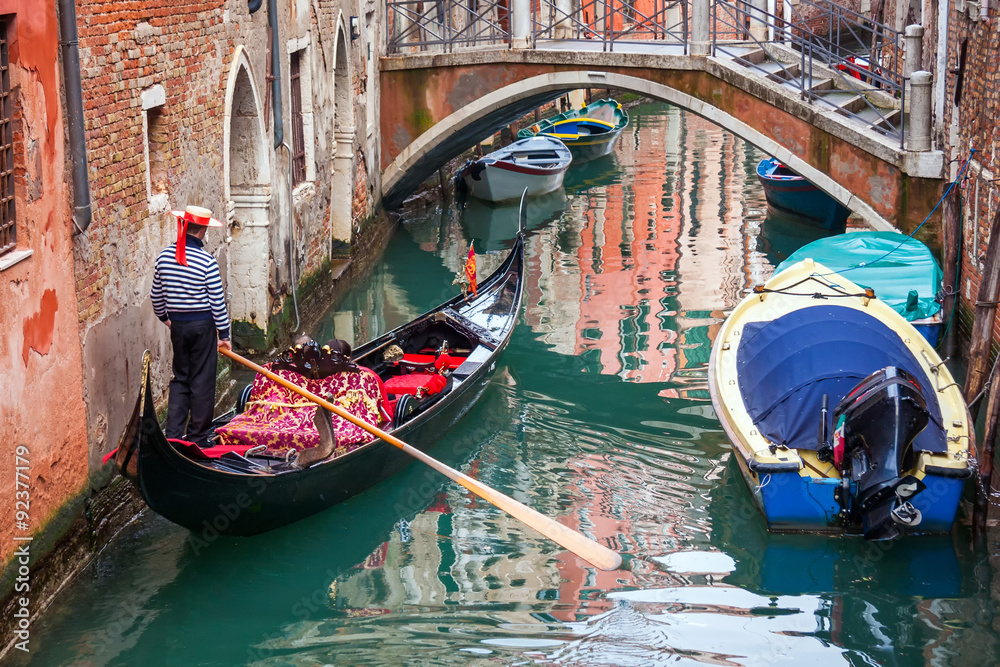 man in gondola in narrow canal with bridge Venice, Italy, Europe - obrazy, fototapety, plakaty 