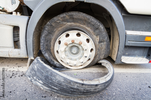 Damaged 18 wheeler semi truck burst tires by highway street