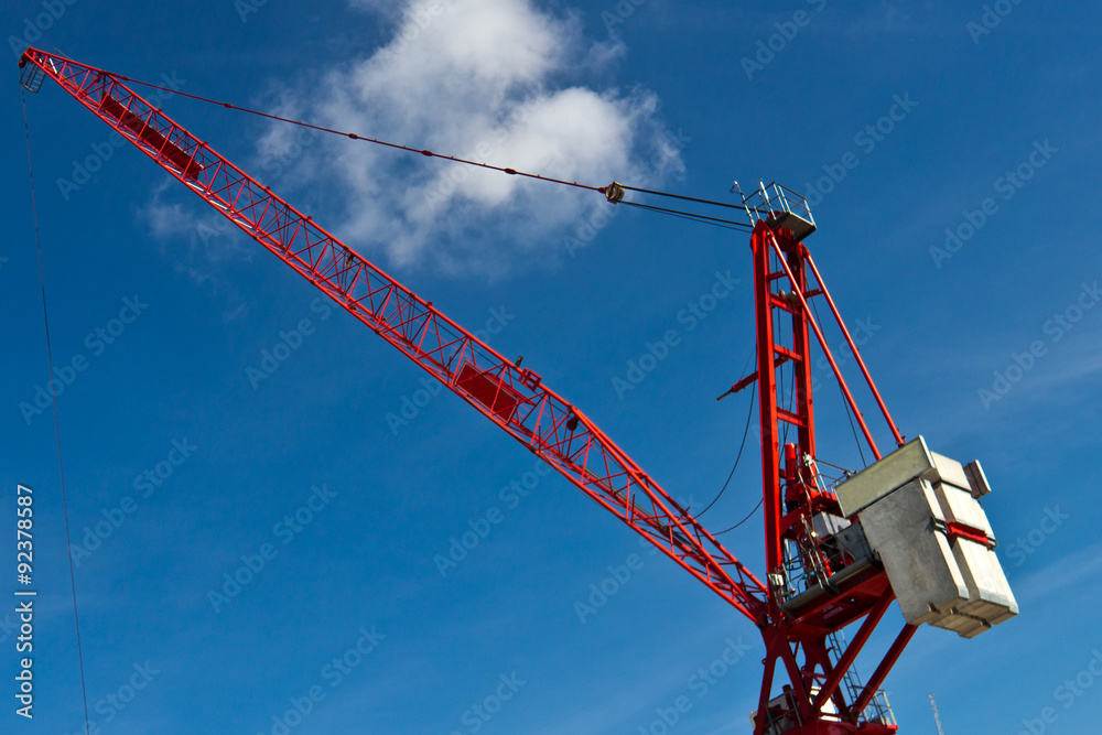Fixed tower crane for construction against a blue sky Fixed tower crane for construction against a blue sky