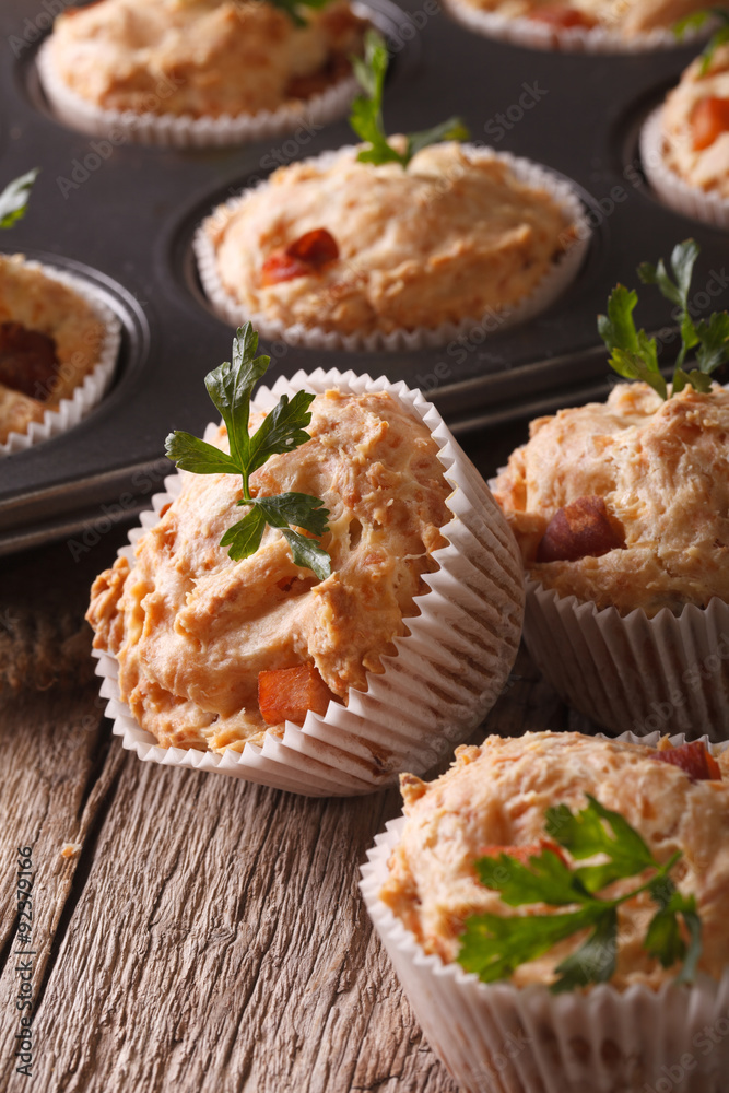 Tasty muffins with ham and cheese close-up. vertical
