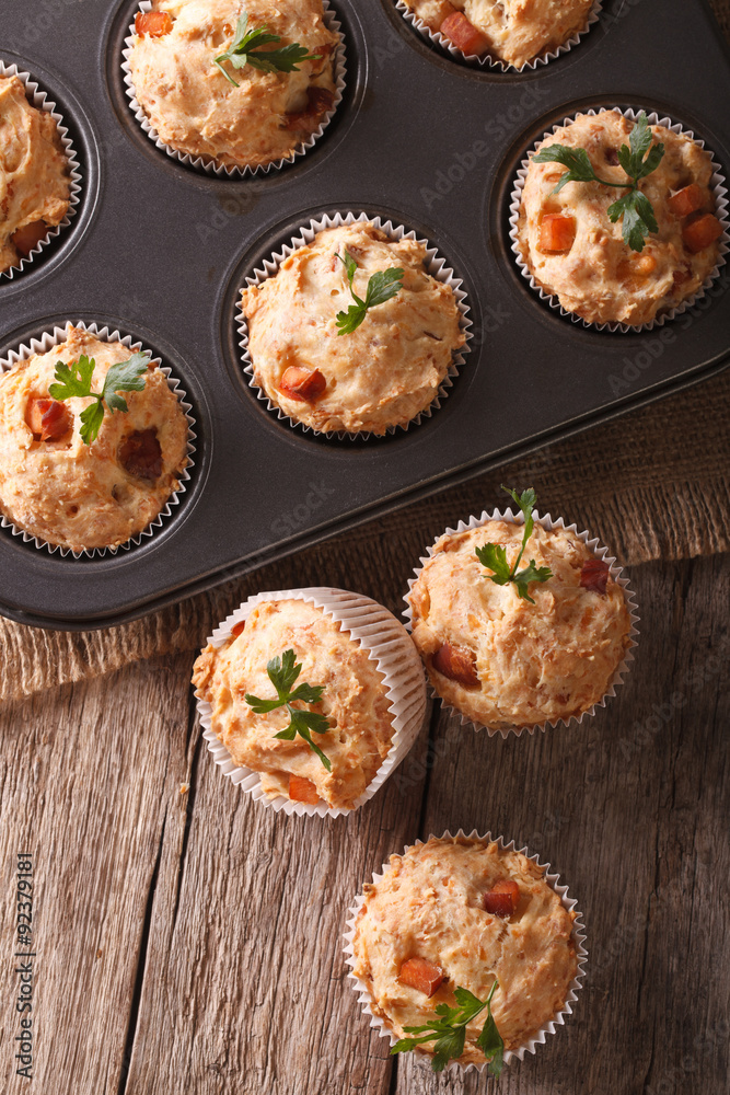 muffins with ham and cheese in baking dish closeup. vertical top view
muffins with ham and cheese in baking dish closeup. vertical top view