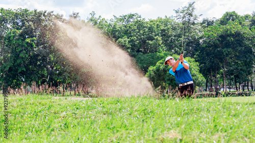 Yong asian golfer explosion sand.
