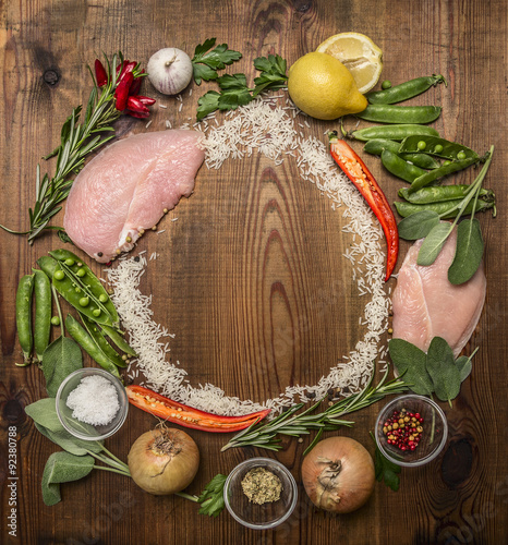 ingredients for making fresh turkey, vegetable,  herbs, spices ,fruit lined circle on wooden rustic background top view
