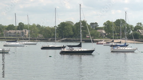 Sailboats moored in harbor photo