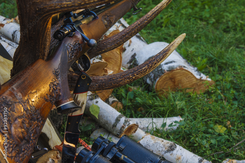 Rifle with hunting knife and binocular Rifle with hunting knife and binocular