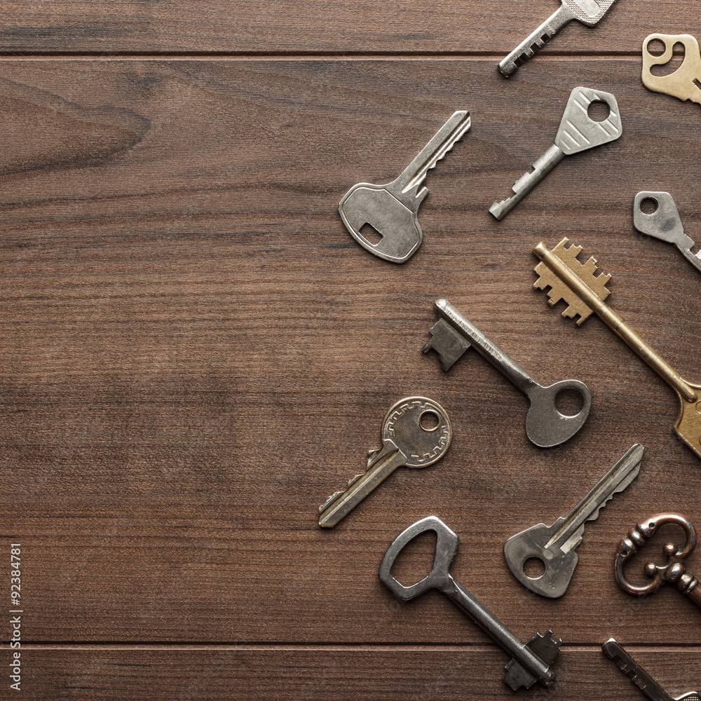 many different keys on wooden table