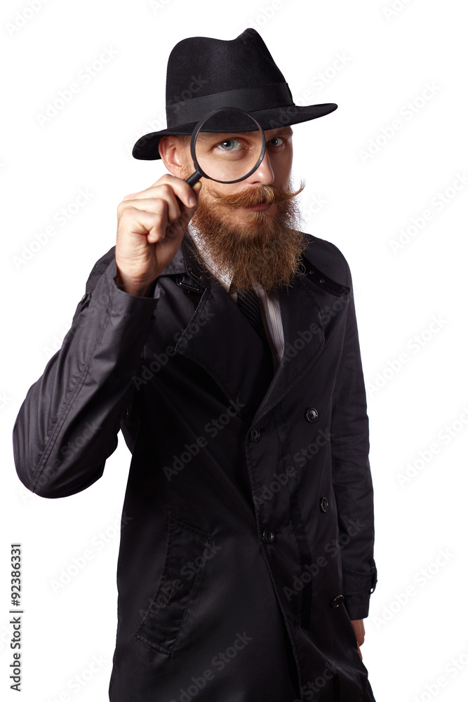 Bearded man looking through a magnifying glass. Bearded man looking through a magnifying glass.