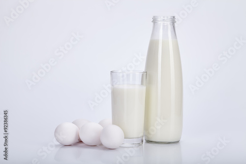 Open bottle milk, glass of milk and eggs