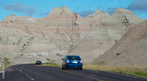 Two cars driving through Badlands National Park in South Dakota