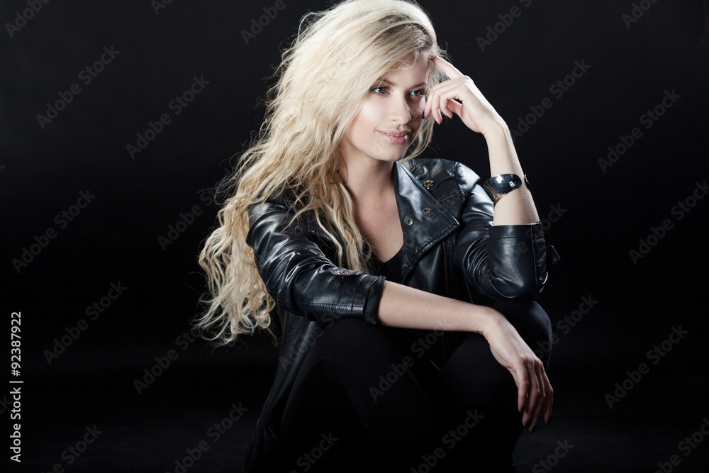 Fototapeta premium Beautiful and stylish young blonde girl, black background