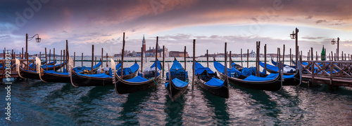 A row of gondolas parked beside the Riva degli Schiavoni in Venice, Italy