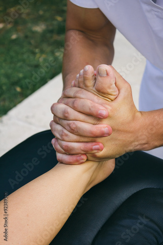 Physiotherapist pressing a foot with his hands