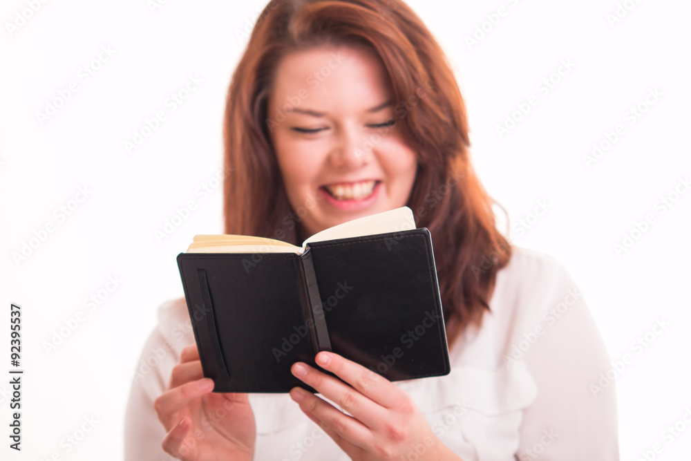 Smiled woman reads black diary Smiled woman reads black diary