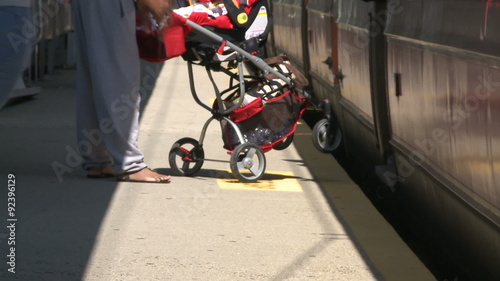 Woman with stroller getting onto train