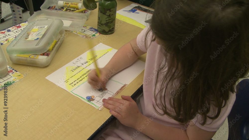 Grammar school student drawing with a pencil Grammar school student drawing with a pencil