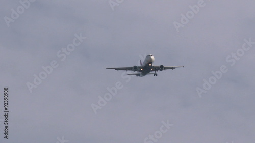 Plane descending from the clouds photo