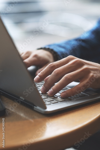 Close up shot of hands typing on laptop 
