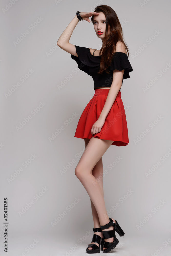 woman in red dress with long curly hair