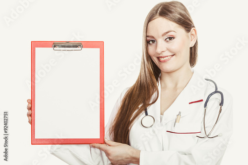 Woman doctor with stethoscope, clipboard and pen. photo