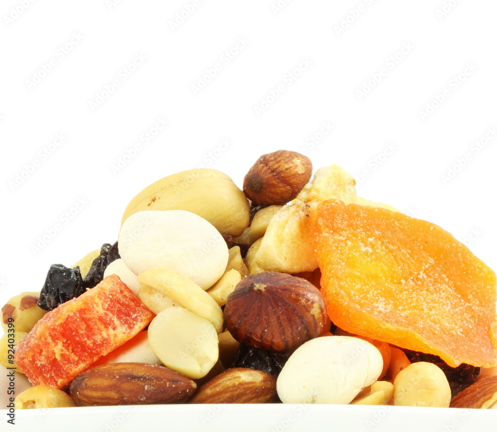 Mixed dried fruits nuts trail mix closeup in white background Mixed dried fruits nuts trail mix closeup in white background