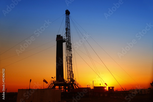 In the evening, the silhouette of oilfield derrick photo