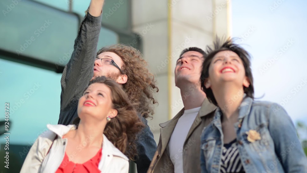 Four young people enjoy exploring new town.
Four young people enjoy exploring new town.