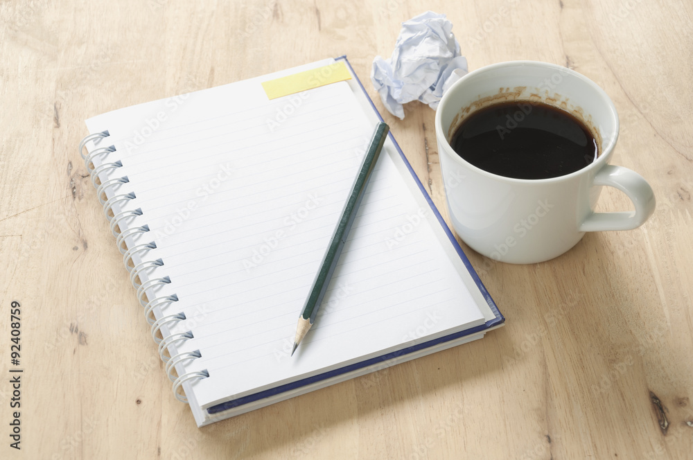 Notebook and coffee on wooden background. Notebook and coffee on wooden background.