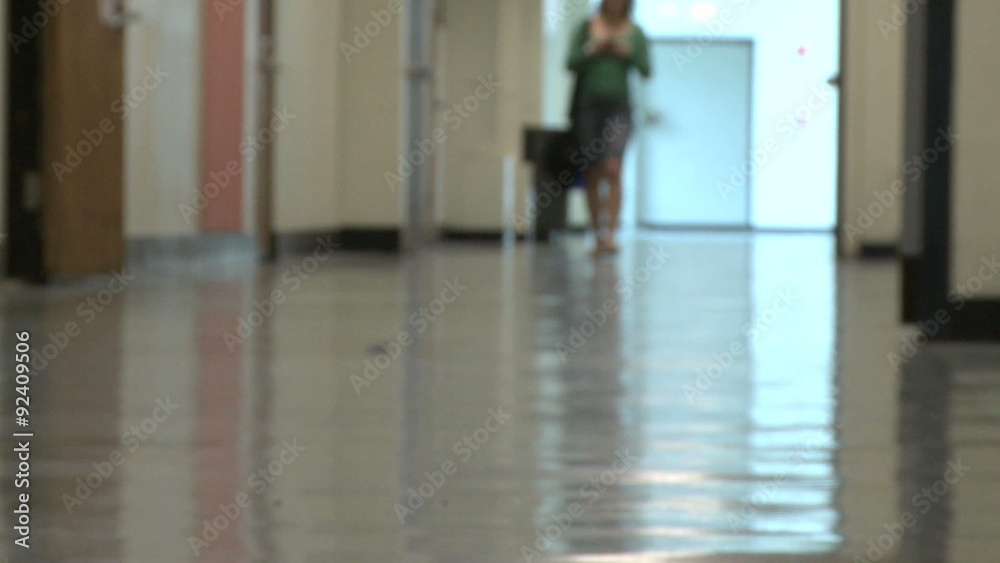 One student walking in hallway