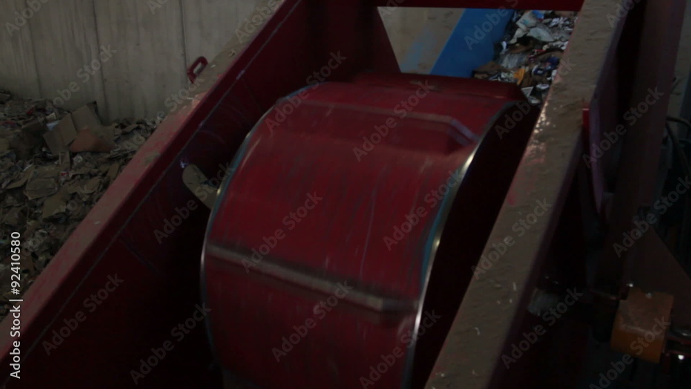 A Large Drum Crushing Cans at a Recycling Center A Large Drum Crushing Cans at a Recycling Center