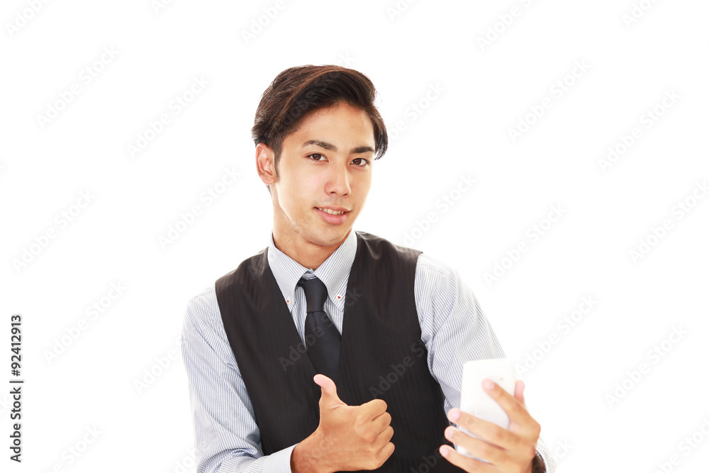 スマホを持つガッツポーズのバーテンダー Stock Photo Adobe Stock