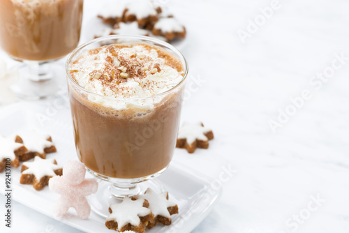 festive pumpkin latte and almond cookies on a white background