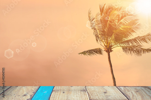 Blur tropical sunset beach with palm tree abstract background.