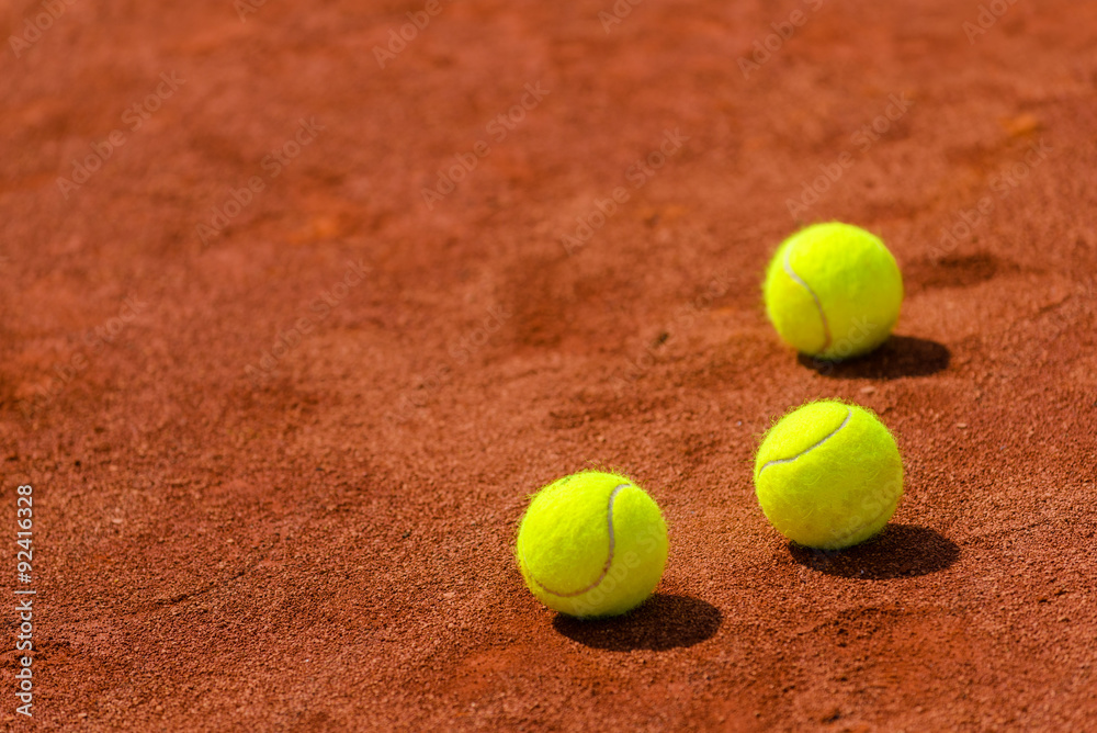 Tennis balls on clay court