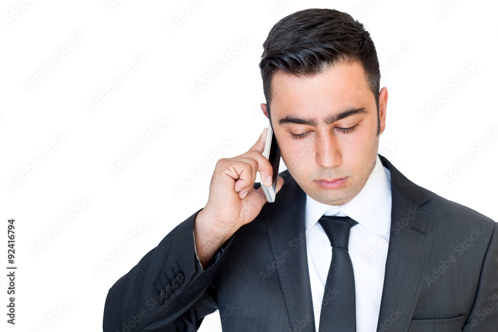 Young businessman talking on the phone with a serious face. Young businessman talking on the phone with a serious face.