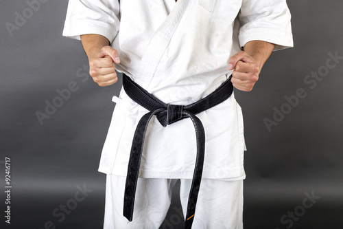 Εκτύπωση καμβά Young man in white kimono and black belt training martial art
