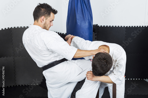 Two young men in kimono fighting during their training photo