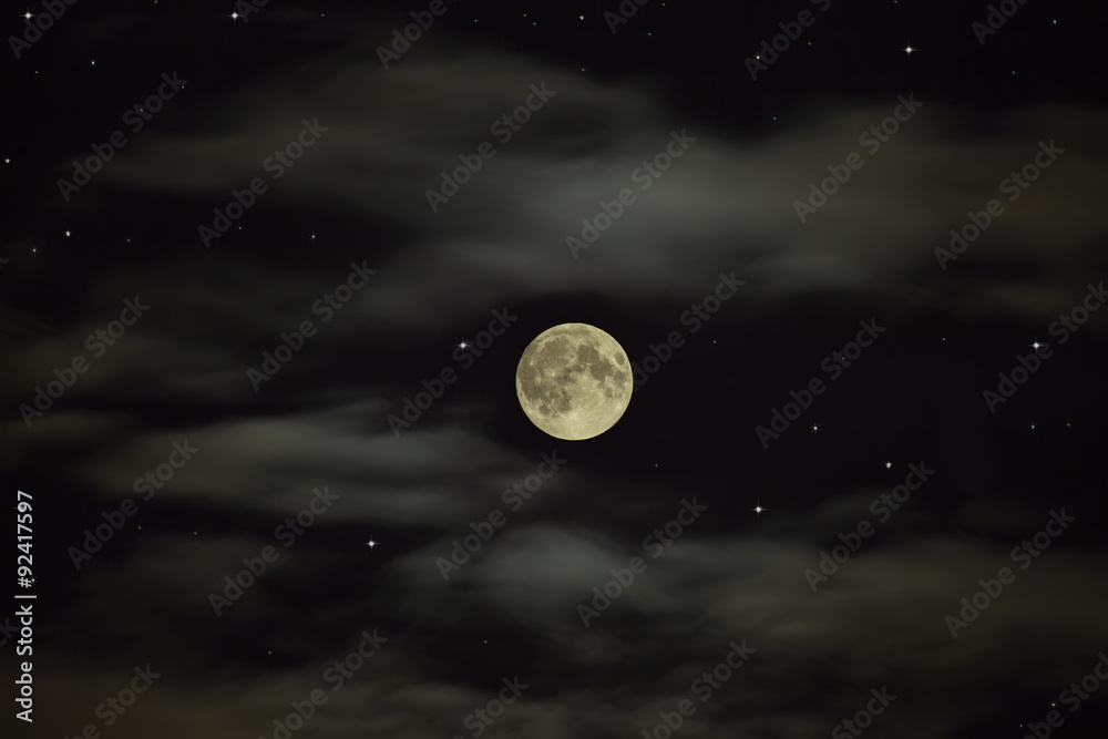 Night sky. Full moon on the starry sky with clouds Night sky. Full moon on the starry sky with clouds