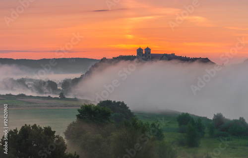 Sunrise over misty Tyniec abbey in Krakow, Poland