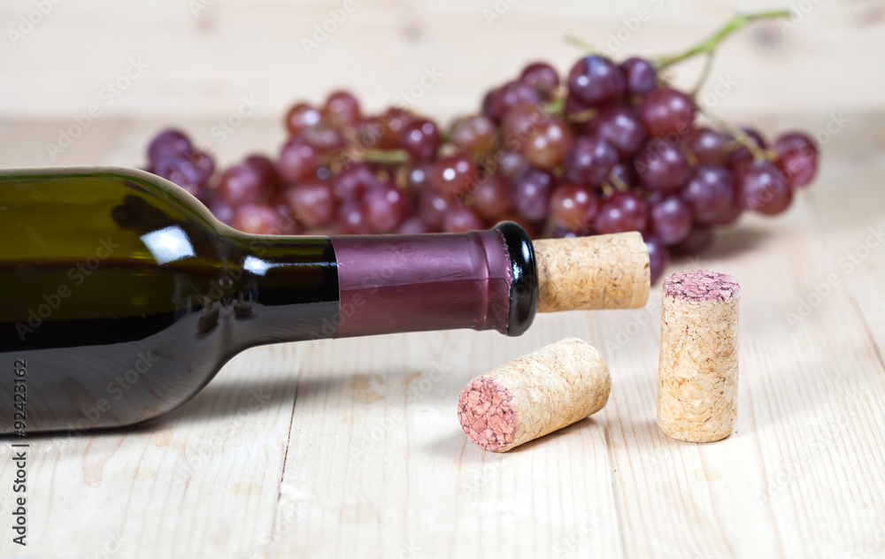 Bottle of  wine and grape  on wooden table