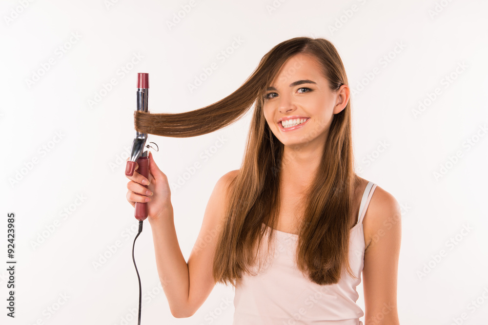 cheerful girl curling her hair cheerful girl curling her hair
