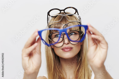Young blond student choosing spectacles