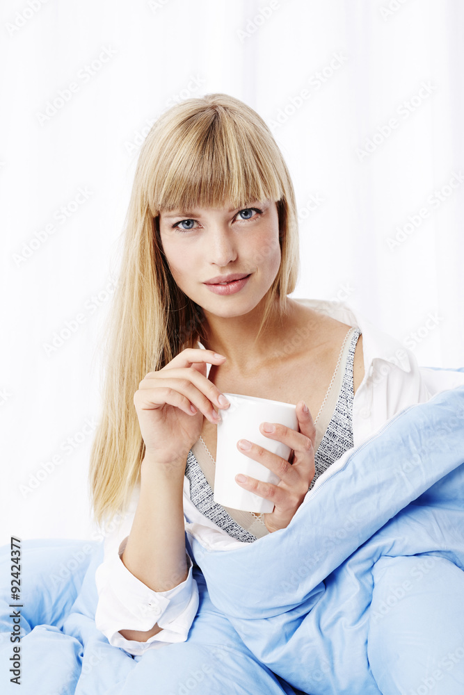 Beautiful blond woman in bed in studio Beautiful blond woman in bed in studio