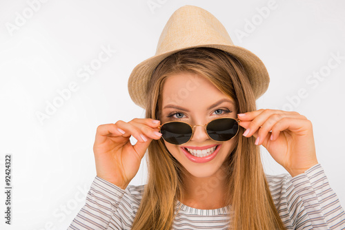 happy girl with a hat putting glasses on her nose