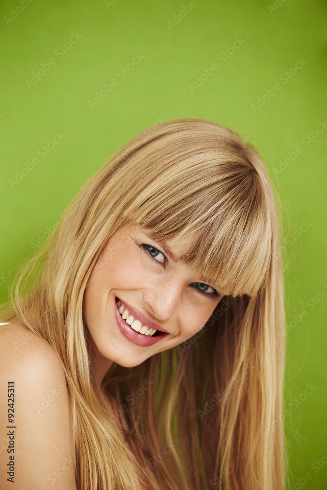 Fototapeta premium Smiling young model on green background