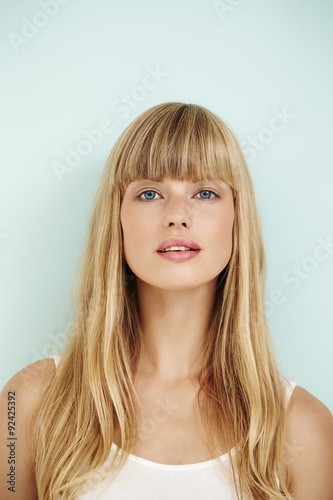 Blond beautiful woman on blue background