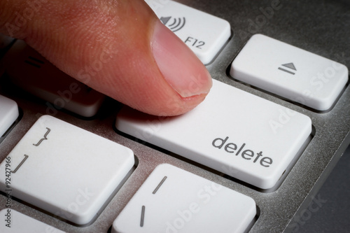 Slika na platnu Closeup of finger on delete key in a keyboard.