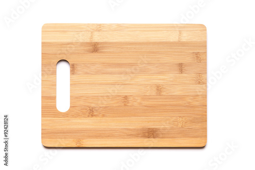 New cutting board made of bamboo on white photo
